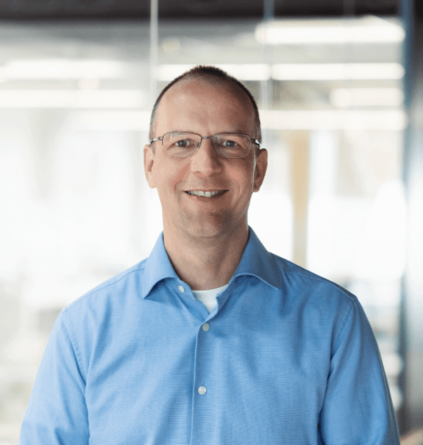A picture of Peter Schneider, Senior Product Manager at QT, in a blue collar shirt.