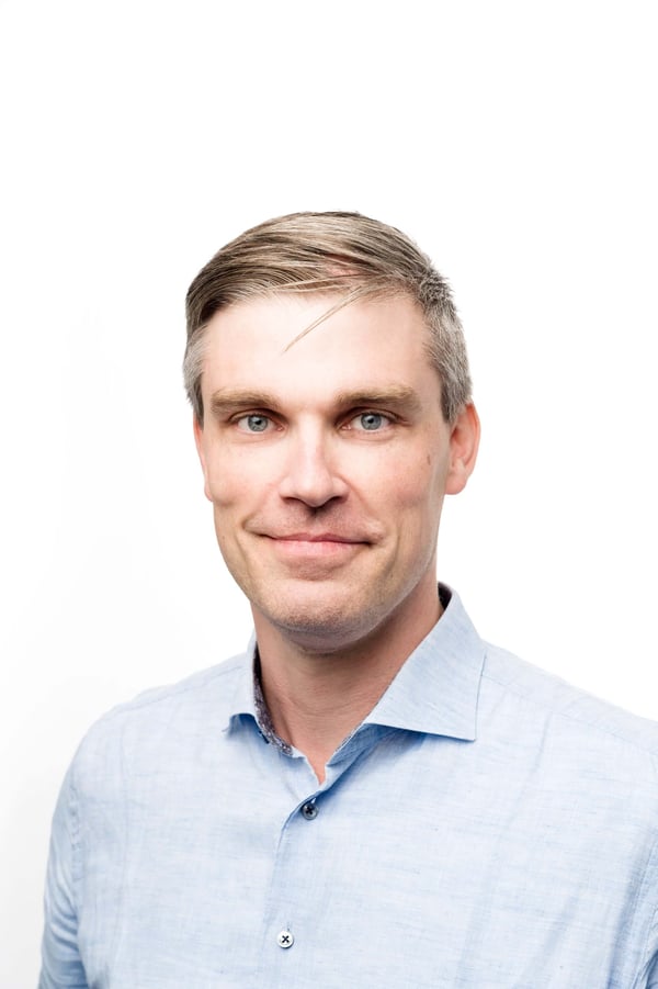 A picture of Eero Jyske, a VP Engineer at Apheris, in a blue collar shirt against a white background.