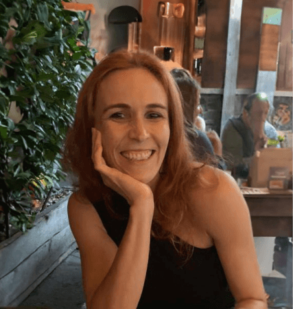 Emmanuelle Byrd, Head of Agility and Process Management at Orange Business smiling to camera while leaning her head in her hand.